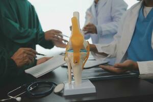 Group of doctors reading a document in meeting room at hospital photo