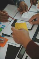 Close up ux developer and ui designer brainstorming about mobile app interface wireframe design on table with customer breif and color code at modern office.Creative digital development agency photo