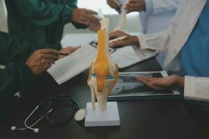 Group of doctors reading a document in meeting room at hospital photo