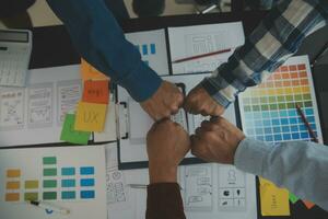 Close up ux developer and ui designer brainstorming about mobile app interface wireframe design on table with customer breif and color code at modern office.Creative digital development agency photo