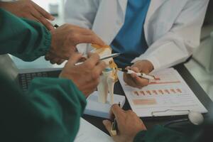 Group of doctors reading a document in meeting room at hospital photo