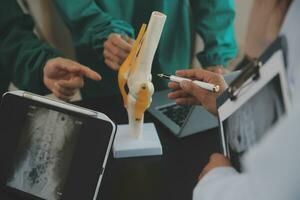 Group of doctors reading a document in meeting room at hospital photo