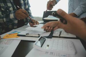 Close up ux developer and ui designer brainstorming about mobile app interface wireframe design on table with customer breif and color code at modern office.Creative digital development agency photo