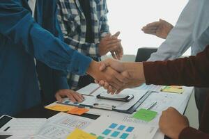 Close up ux developer and ui designer brainstorming about mobile app interface wireframe design on table with customer breif and color code at modern office.Creative digital development agency photo