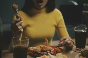 fat woman bite piece of pizza,overweight female is eating fast foods,asian girl is hungry photo