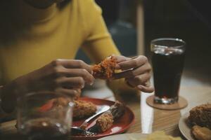 fat woman bite piece of pizza,overweight female is eating fast foods,asian girl is hungry photo