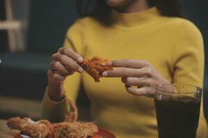 fat woman bite piece of pizza,overweight female is eating fast foods,asian girl is hungry photo