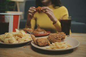 fat woman bite piece of pizza,overweight female is eating fast foods,asian girl is hungry photo