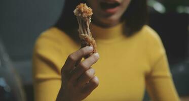 fat woman bite piece of pizza,overweight female is eating fast foods,asian girl is hungry photo