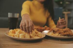 fat woman bite piece of pizza,overweight female is eating fast foods,asian girl is hungry photo