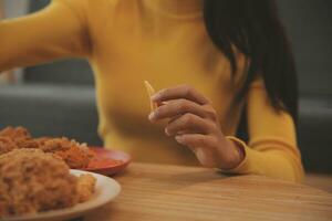 fat woman bite piece of pizza,overweight female is eating fast foods,asian girl is hungry photo