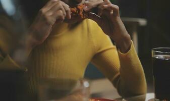 fat woman bite piece of pizza,overweight female is eating fast foods,asian girl is hungry photo