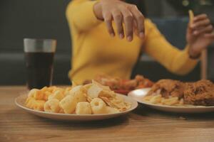 fat woman bite piece of pizza,overweight female is eating fast foods,asian girl is hungry photo