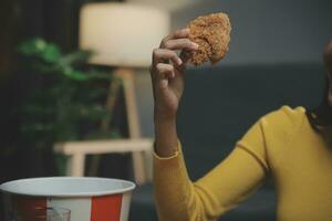 fat woman bite piece of pizza,overweight female is eating fast foods,asian girl is hungry photo