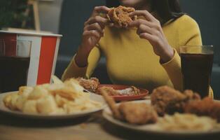 fat woman bite piece of pizza,overweight female is eating fast foods,asian girl is hungry photo