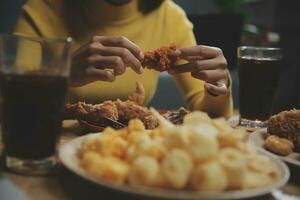 fat woman bite piece of pizza,overweight female is eating fast foods,asian girl is hungry photo