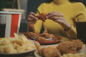 fat woman bite piece of pizza,overweight female is eating fast foods,asian girl is hungry photo