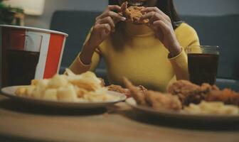 fat woman bite piece of pizza,overweight female is eating fast foods,asian girl is hungry photo