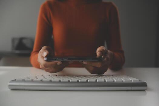 Asian Businesswoman Using laptop computer and working at office with calculator document on desk, doing planning analyzing the financial report, business plan investment, finance analysis concept. photo