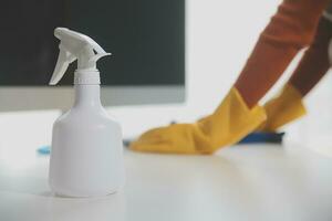 Office Cleaning Service. Janitor Spraying Desk. Workplace Hygiene photo