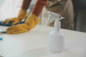 Office Cleaning Service. Janitor Spraying Desk. Workplace Hygiene photo