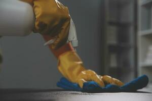 Office Cleaning Service. Janitor Spraying Desk. Workplace Hygiene photo