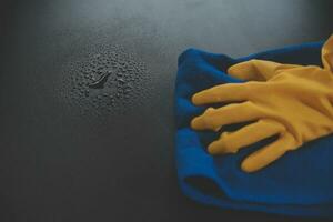 Office Cleaning Service. Janitor Spraying Desk. Workplace Hygiene photo