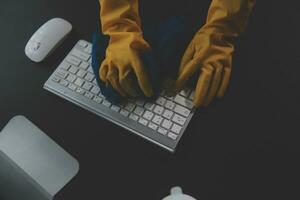 Office Cleaning Service. Janitor Spraying Desk. Workplace Hygiene photo