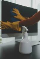 Office Cleaning Service. Janitor Spraying Desk. Workplace Hygiene photo