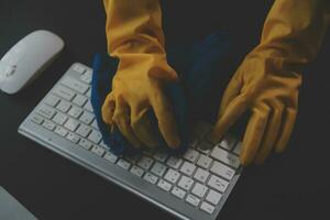 Office Cleaning Service. Janitor Spraying Desk. Workplace Hygiene photo