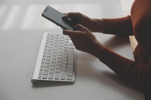 Asian Businesswoman Using laptop computer and working at office with calculator document on desk, doing planning analyzing the financial report, business plan investment, finance analysis concept. photo