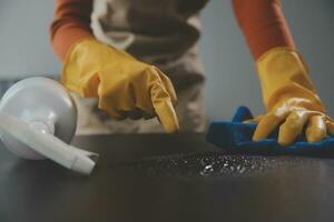 Office Cleaning Service. Janitor Spraying Desk. Workplace Hygiene photo