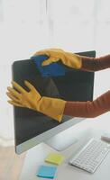Office Cleaning Service. Janitor Spraying Desk. Workplace Hygiene photo