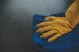 Office Cleaning Service. Janitor Spraying Desk. Workplace Hygiene photo