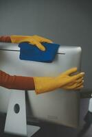 Office Cleaning Service. Janitor Spraying Desk. Workplace Hygiene photo