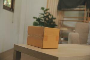 Beautiful young couple in love having fun unpacking things from cardboard boxes while moving in together in their new apartment photo