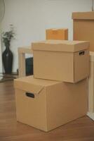 Beautiful young couple in love having fun unpacking things from cardboard boxes while moving in together in their new apartment photo