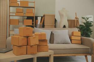 Beautiful young couple in love having fun unpacking things from cardboard boxes while moving in together in their new apartment photo