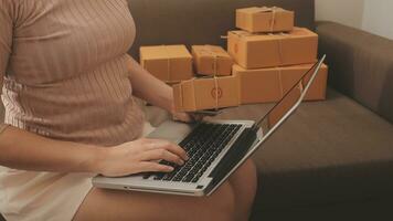 Business woman start up small business entrepreneur SME success .freelance woman working at home with Online Parcel delivery. SME and packaging deliveryconcept photo