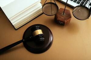 Business and lawyers discussing contract papers with brass scale on desk in office. Law, legal services, advice, justice and law concept picture with film grain effect photo