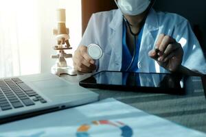 Young scientists conducting research investigations in a medical laboratory, a researcher in the foreground is using a microscope photo