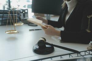 Male lawyer working with contract papers and wooden gavel on tabel in courtroom. justice and law ,attorney, court judge, concept. photo