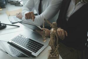Male lawyer working with contract papers and wooden gavel on tabel in courtroom. justice and law ,attorney, court judge, concept. photo