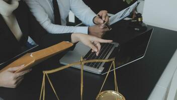 Male lawyer working with contract papers and wooden gavel on tabel in courtroom. justice and law ,attorney, court judge, concept. photo