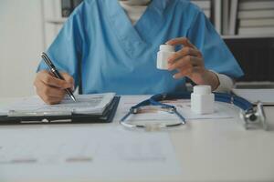 Doctor writing out RX prescription selective focus photo