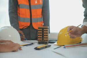 Construction and structure concept of Engineer or architect meeting for project working with partner and engineering tools on model building and blueprint in working site, contract for both companies. photo