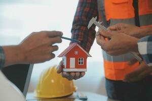 Construction and structure concept of Engineer or architect meeting for project working with partner and engineering tools on model building and blueprint in working site, contract for both companies. photo