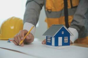 Construction and structure concept of Engineer or architect meeting for project working with partner and engineering tools on model building and blueprint in working site, contract for both companies. photo