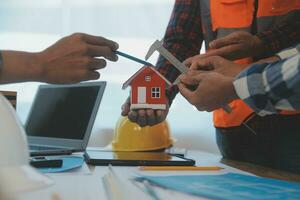 Construction and structure concept of Engineer or architect meeting for project working with partner and engineering tools on model building and blueprint in working site, contract for both companies. photo