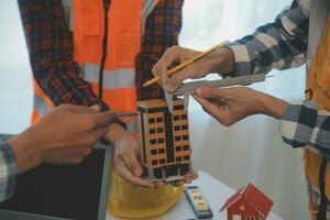 Construction and structure concept of Engineer or architect meeting for project working with partner and engineering tools on model building and blueprint in working site, contract for both companies. photo